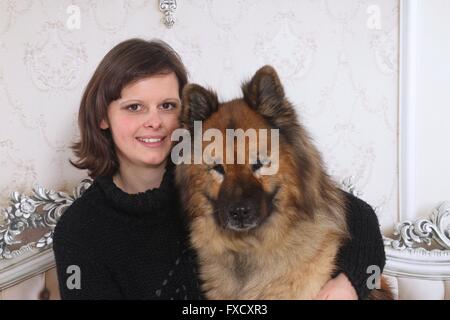 woman and Eurasian Dog Stock Photo