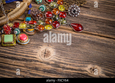 Colorful stones necklaces on wooden surface, space for text Stock Photo