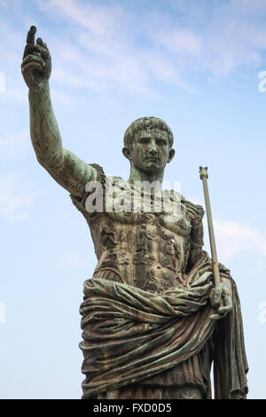 Ancient statue S.P.Q.R. IMP CAESAR Augustus PATRIAE PATER over cloudy sky. Via dei Fori Imperiali street, Rome, Italy Stock Photo
