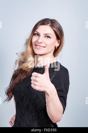 Young woman with thumbs up gesture Stock Photo