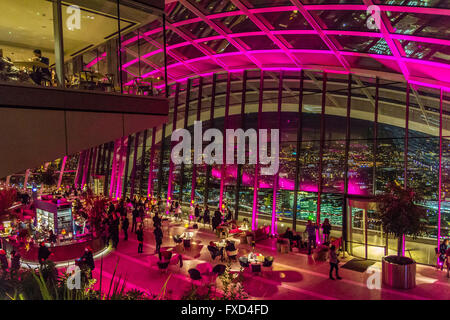 People at the  he Sky Pod Bar at night at the top of 20 Fenchurch St, also known as the Walkie Talkie Building, London, UK Stock Photo