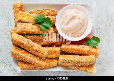 Fried zucchini breaded cheese and white sauce Stock Photo