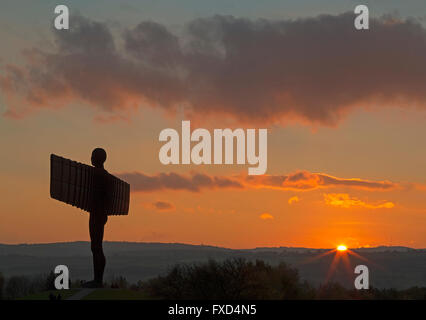 The Angel of the North in Gateshead at sunset with the setting sun clearly visible in a clear sky Stock Photo