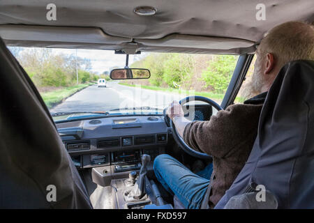 Man driving a car on a road, Nottinghamshire, England, UK. Viewed from inside a Range Rover. Stock Photo