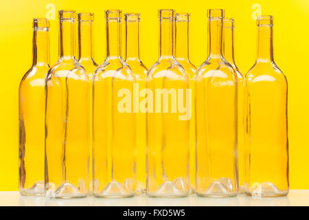 Ten empty glass bottles standing in a row Stock Photo