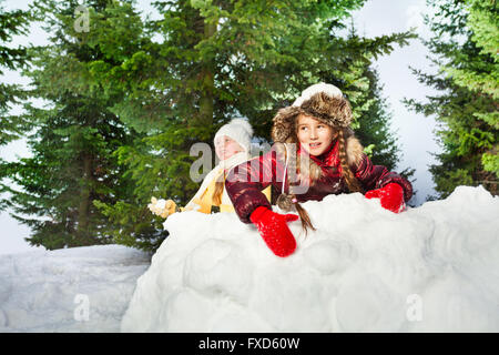 Cute girls playing the snowballs on a winter's day Stock Photo