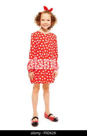 Stylish curly-haired girl in red polka-dot dress Stock Photo