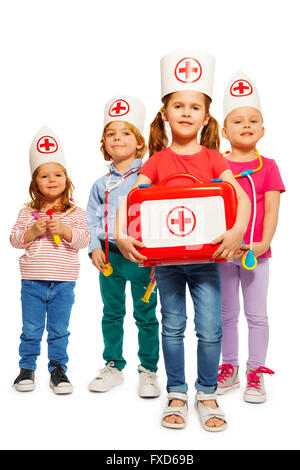 Little doctors with medical box giving first aid Stock Photo