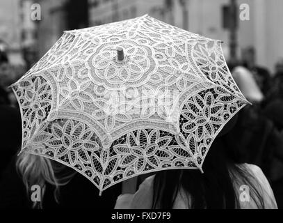 retro umbrella all hand-decorated with lace doilies and two women Stock Photo