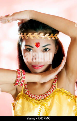 Young Asian woman as exotic dancer in studio setting Stock Photo