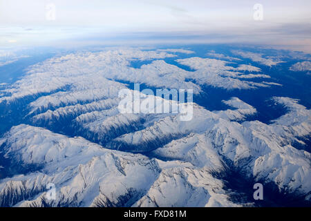 Flying above the Austrian Alps on sunny winter day Stock Photo