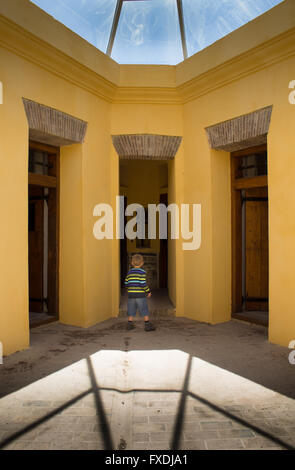 Historic Castle of Good Hope star fort circa 1700 in Cape Town South Africa with small boy in awe at entrance of old jail cells Stock Photo
