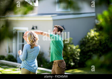 Couple dancing in yard Stock Photo