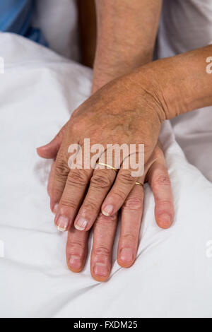 Cropped image of couple touching hands Stock Photo
