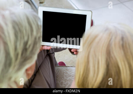 High angle view of senior couple holding digital tablet Stock Photo