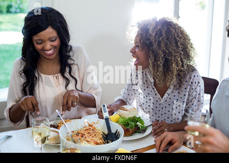 Friends talking while having meal Stock Photo