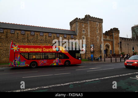 Open topped double decker tour bus in front of the Black Tower, South Gate and barbican, the main entrance to Cardiff Castle, South Glamorgan, Wales Stock Photo