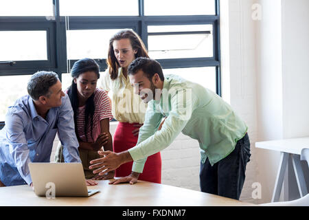 Colleagues discussing on laptop Stock Photo