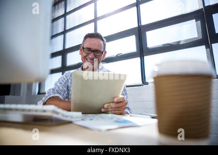 Happy man using digital tablet Stock Photo