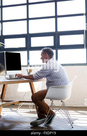 Man working on computer in office Stock Photo