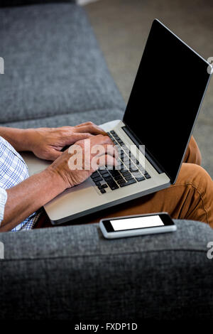 Man using laptop in office Stock Photo