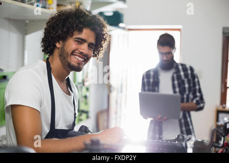 Bike mechanic repairing a bicycle Stock Photo