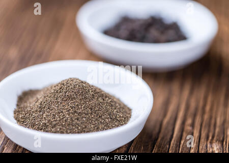 Milled Pepper (close-up shot; selective focus) on vintage wooden background Stock Photo