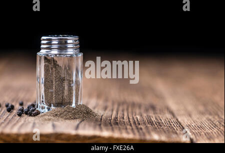 Pepper shaker of ground paprika pepper on a wooden background Stock Photo -  Alamy