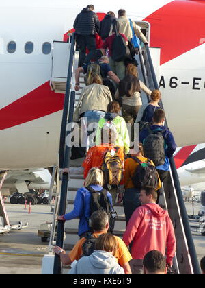 Passengers climbing stairway to board Emirates flight Stock Photo