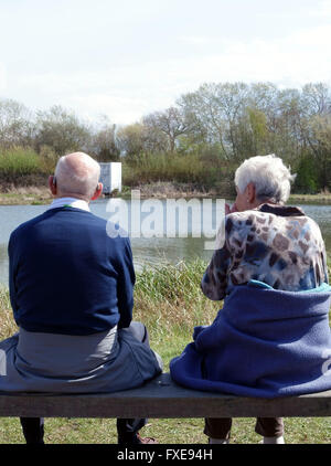 Older couple sitting on bench in nature reserve, London Stock Photo