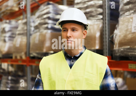 man in hardhat and safety vest at warehouse Stock Photo