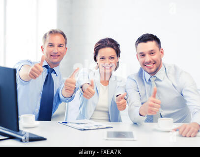 business team showing thumbs up in office Stock Photo