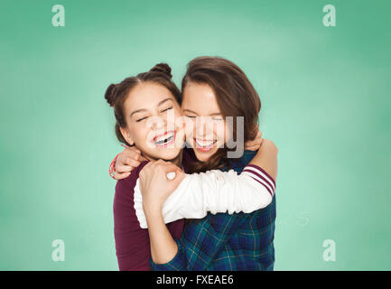 happy smiling teenage student girls hugging Stock Photo