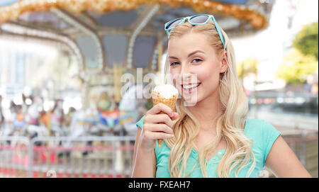 happy young woman in sunglasses eating ice cream Stock Photo