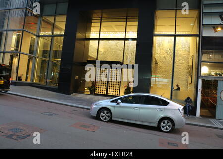 Urban scene, A parked car in front of a hotel in the streets of hong kong. Stock Photo