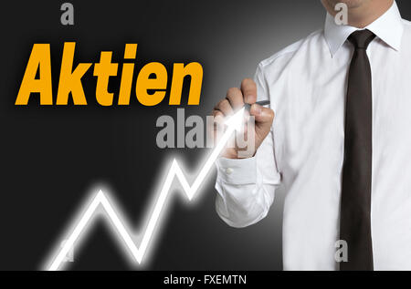 aktien (in german shares) trader draws market price on touchscreen. Stock Photo