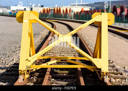 Bright yellow train buffer stop or bumper at the end of a railway track. Stock Photo