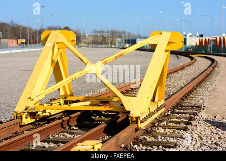 Bright yellow train buffer stop or bumper at the end of a railway track. Stock Photo