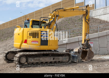 Parked Backhoe At Construction Site Stock Photo