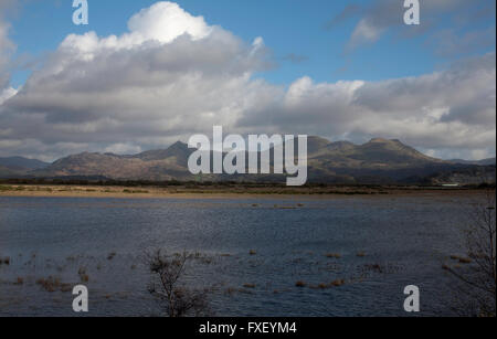 Moelwyn Mountains and Cnicht looking across the flooded estuary of The Afon Glaslyn from the Cob at Porthmadog Snowdonia Wales Stock Photo