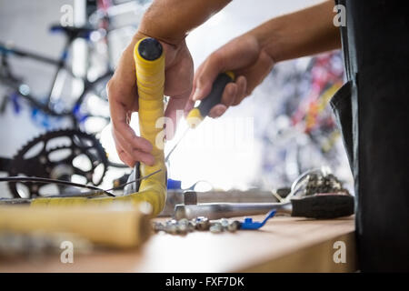 Close-up of worker repairing bicycles Stock Photo