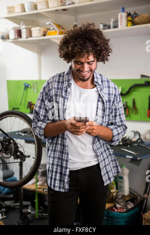 Smiling worker using phone Stock Photo