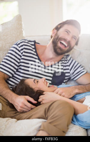 Happy couple having fun on sofa Stock Photo