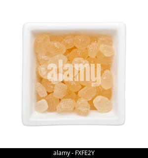 Brown rock sugar in a square bowl isolated on white background Stock Photo