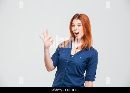 Cheeky Playful Redhead Female in Striped T-shirt Wink Suggestive
