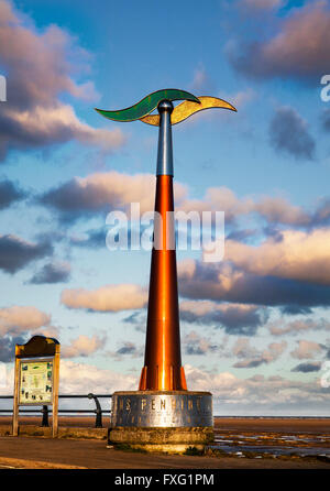 Rotating tall spinning weathervane Southport, Seafront & Promenade attractions. Colourful sunset over the Irish Sea on the north west coast of Sefton.  UK Weather wind vane, wind speed and direction instrument;   This device is a TPT Seamark on Southport’s Promenade, a  tall towering outdoor weather station wind spinner, which serves as a marker for the start of the east-west trail of The Trans Pennine coast-to-coast trail. Stock Photo