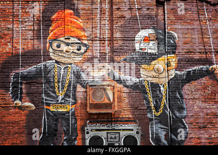 GLASGOW APRIL 02, 2016; Wall mural by artist Rogue One called 'Hip Hop Marionettes'. Glasgow, Scotland. Stock Photo