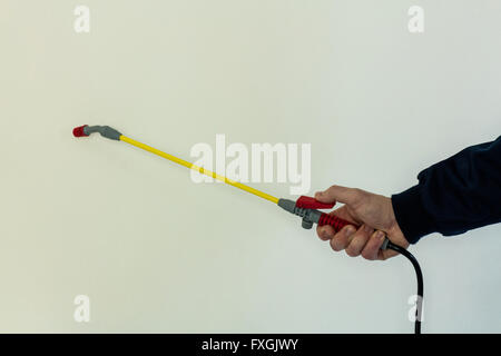 Mans hand spraying pesticide Stock Photo