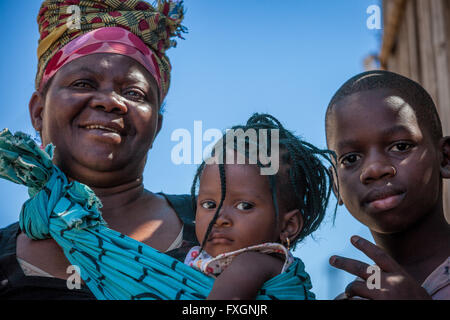 Mozambique, a portrait of a family, mother, baby girl, boy in traditional clothes. Stock Photo