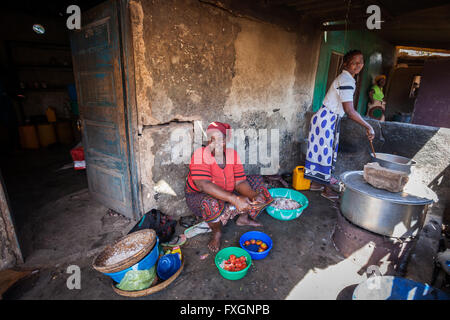Mozambique, women are cooking in the kitchen traditional cousin dishes. Stock Photo